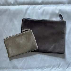 2 Bloomingdales metallic zipper pouches.